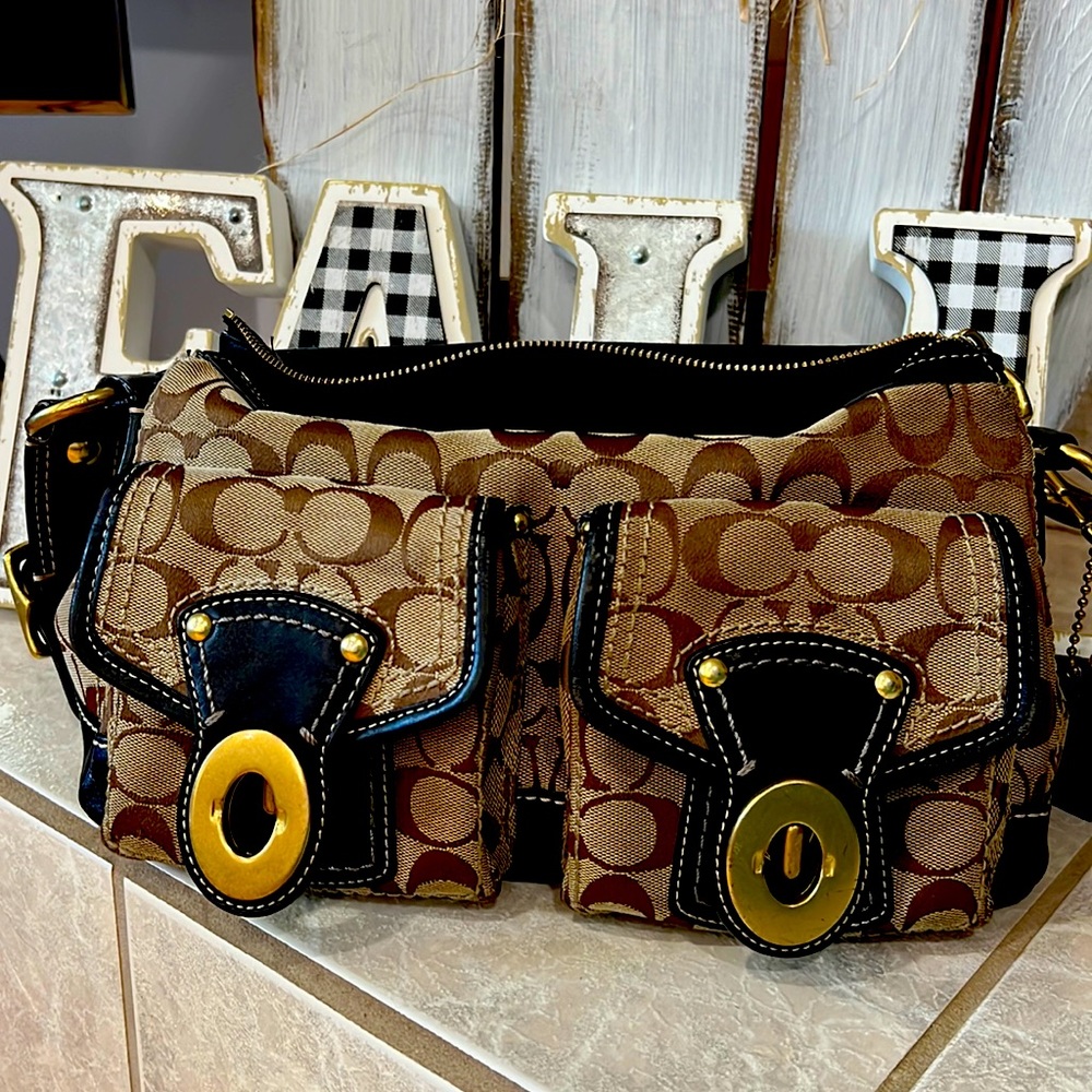 Coach purse brown with black leather detailing.